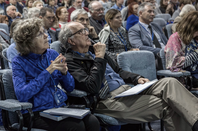 Stephanie Guildford and Bob Hecky listen attentively during a conference session.